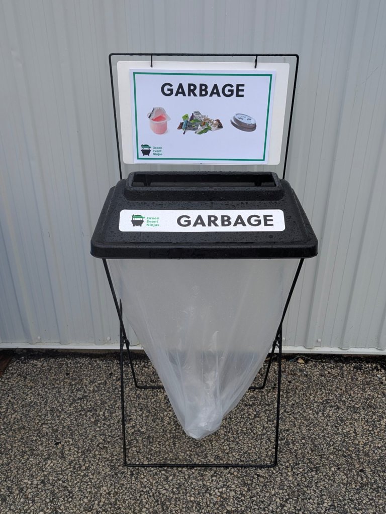 Single X-frame event garbage bin with black lid, clear bag and sign