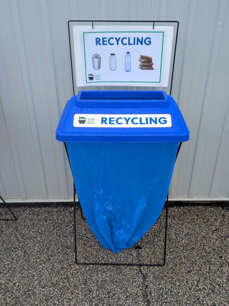 Single X-frame event recycling bin with blue lid, blue bag and sign