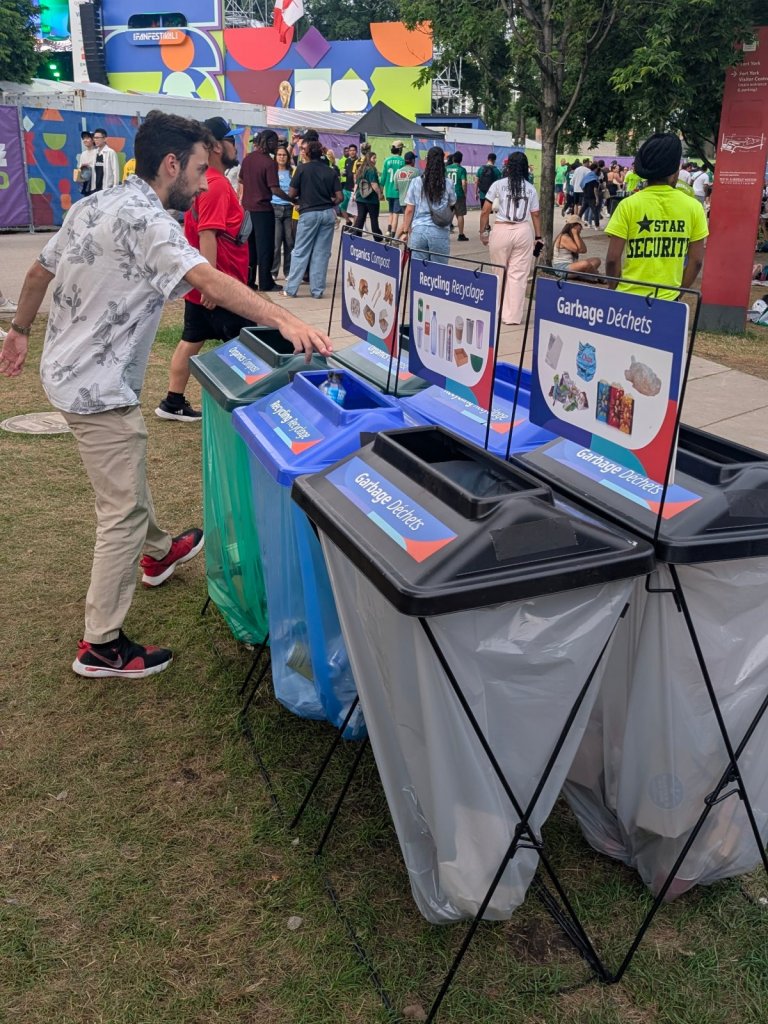 Festival-goer dropping waste into a Green Event Ninjas garbage bin at the Toronto FIFA Fan Festival 2026